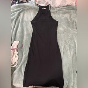 Black knee length sleeveless dress.